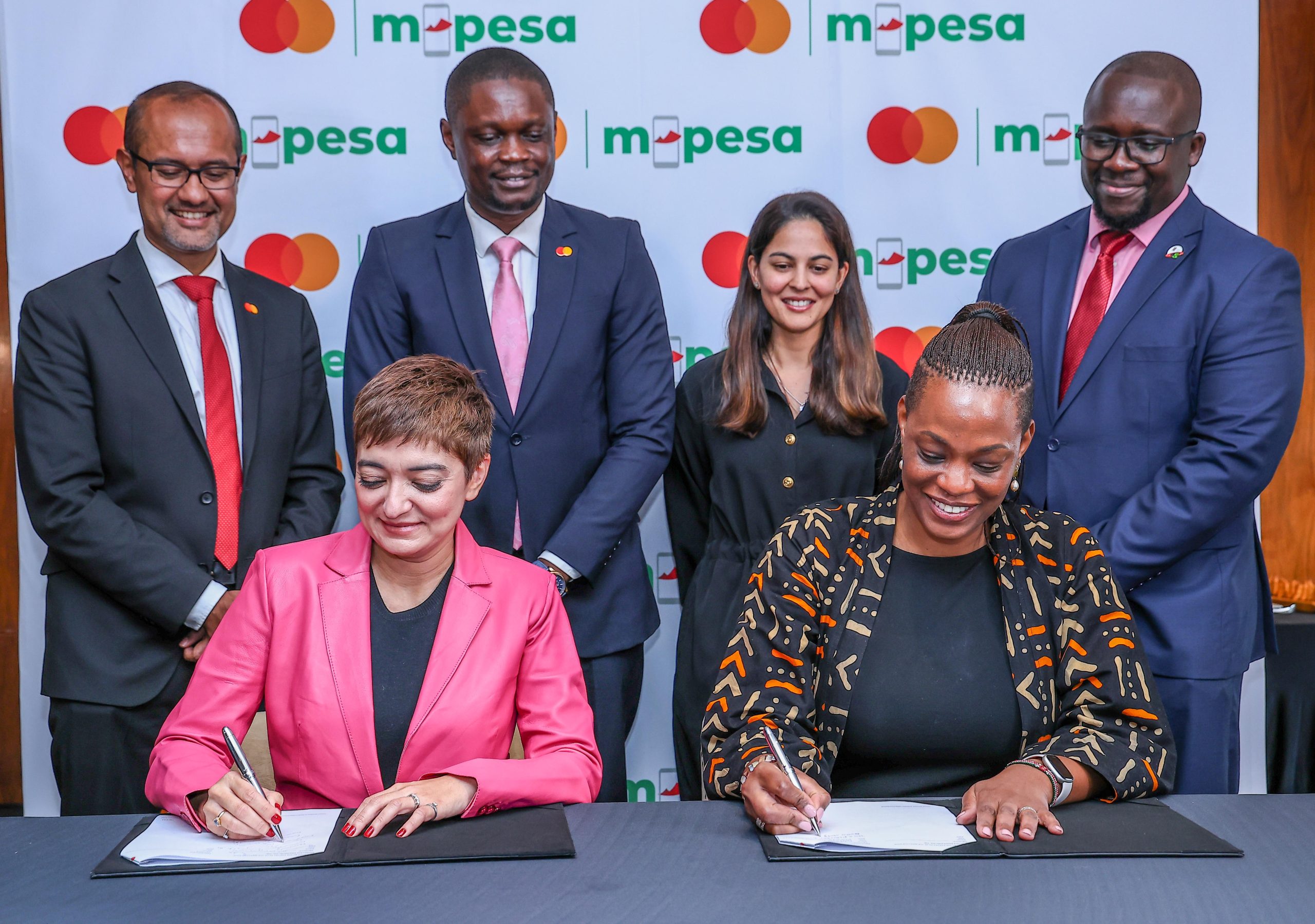 Safaricom and Mastercard officials signing